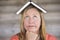 Thoughtful smart woman with book on head