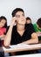 Thoughtful Teenage Schoolboy Leaning At Desk