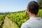 Thoughtful vintner standing in vineyard