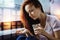 Thoughtful woman looking at the pills and holding a glass of water