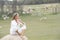 Thoughtful woman outdoor sitting on rock