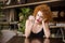 Thoughtful woman sitting at the table in restaurant