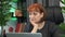 Thoughtful woman is sitting at workplace desk with laptop computer. Pensive businesswoman is thinking at table in office. Focused