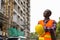 Thoughtful young black African man construction worker holding c