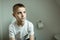 Thoughtful Young Boy Sitting on Toilet Seriously