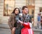 Thoughtful young couple riding scooter bike in autumn town together