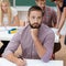 Thoughtful young man in a university class