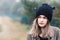 Thoughtful young woman in black woolen cap