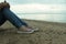 A thoughtful young woman sitting in the beach side alone. Enjoy the solitude