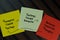 Thoughts Create Feeling - Feelings Create Behavior - Behavior Reinforces Thoughts circle write on sticky notes isolated on Wooden