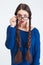 Thoughtul woman with two long braids looking over glasses