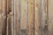 Threadbare clapboards texture. Old weathered wall of rustic barn covered with worn wooden planks for background.