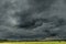 Threatening dark rain clouds over a vast plain.