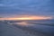 A threatening stormy but picturesque tropical orange and grey coloured cloudy coastal sunrise seascape