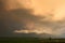 Threatening thunderstorm in Transylvania is colorfully illuminated at sunset