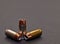 Three 40 caliber hollow point bullets on a gray background