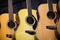 Three acoustic guitars hanging in a row - generic