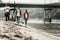 Three active students enjoying volunteering greatly while cleaning the beach