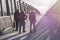 Three adolescents walking across pedestrian bridge near Mexican border
