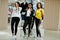 Three afican american women in tracksuits shopping and show thumb up at sportswear mall against mannequin. Sport store theme