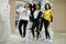 Three afican american women in tracksuits shopping and show thumb up at sportswear mall against mannequin. Sport store theme