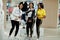 Three afican american women in tracksuits shopping at sportswear mall against mannequin. Sport store theme