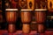 three african djembe drums in a row