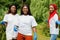 Three african volunteer womans in park. Africa volunteering, charity, people and ecology concept