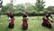 Three african women dancing a folk dance in traditional costumes with wicker baskets