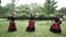 Three african women dancing a folk dance in traditional costumes with wicker baskets