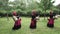 Three african women are dancing a folk dance in traditional costumes with wicker baskets