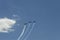 Three aircraft in the sky make aerobatics