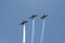 Three aircraft in the sky make aerobatics