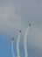 Three airplanes on air show with trails