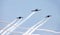 Three airplanes in formation with smoke