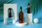 Three amber glass bottles with trendy geometric shapes on a blue background.