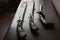 Three ancient guns lay on dark wooden table