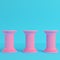 Three ancient pillars on bright blue background in pastel colors