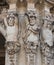 Three ancient statues of satyrs holding something