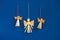 Three angel figures on blue wall, christmas decoration.