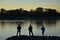 Three anglers by the river Rhine