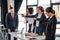 Three angry young businesswomen pointing with fingers at upset businessman in office