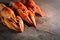 Three appetizing boiled lobster on a dark wooden background