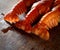 Three appetizing boiled lobster on a dark wooden background