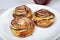 Three apple tartlets on white plate