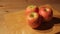 Three apples on a cutting board