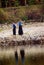 Three Arab women dressed completely in black carrying jerry cans on their heads filled with water from the Nile River in Egypt, ne