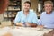 Three Architects Sitting Around Table Having Meeting