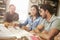 Three Architects Sitting Around Table Having Meeting