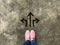 Three arrow and pink slipper shoe on concrete background